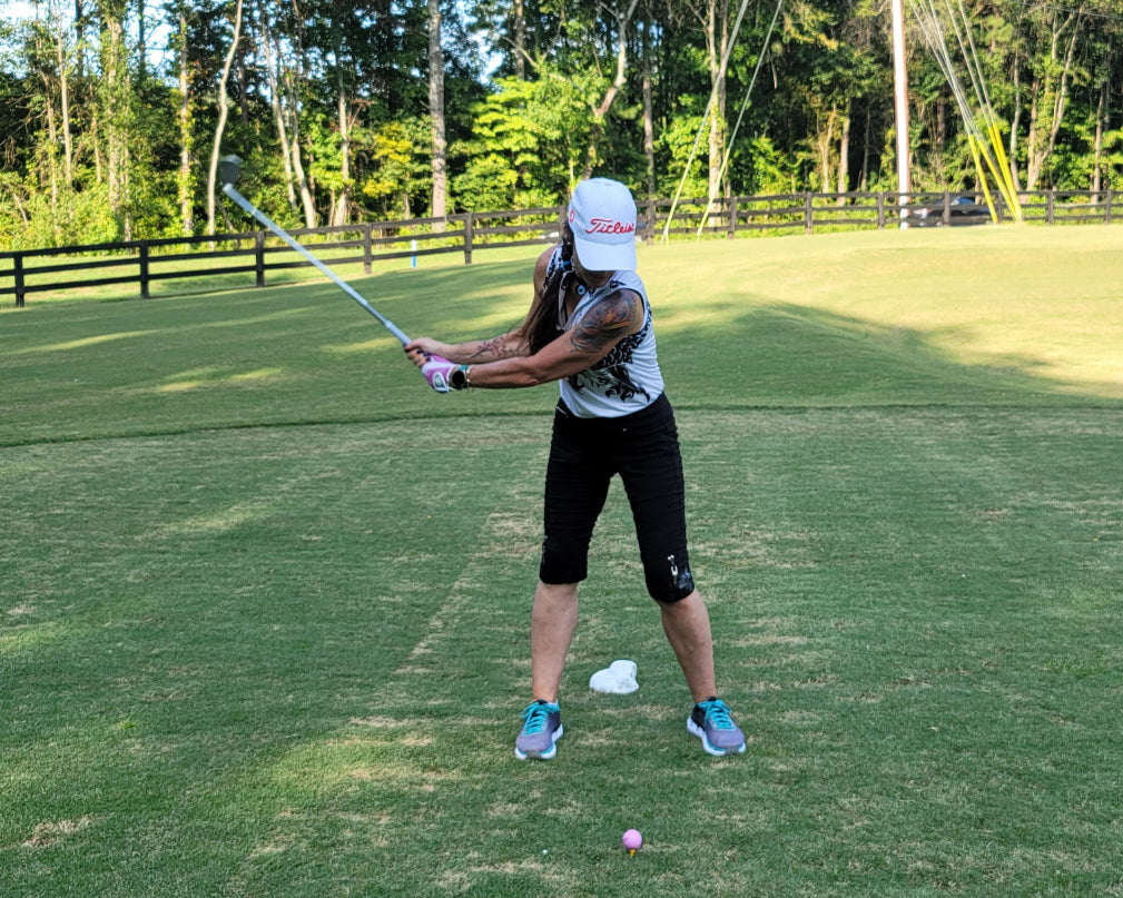 toned woman playing golf