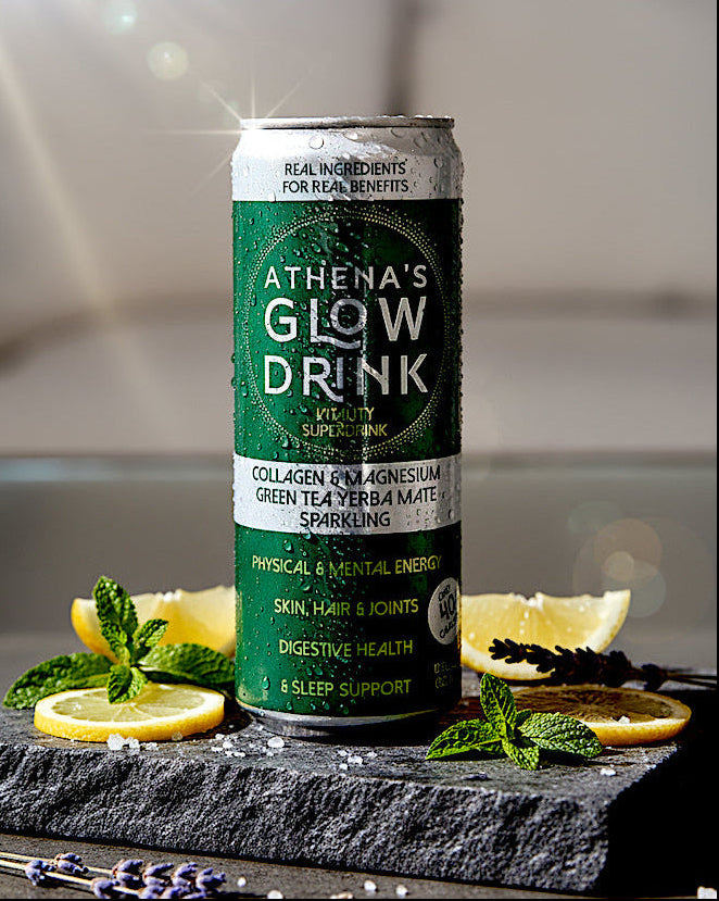 Athena's Glow Drink Sparkling can on a stone surface with lemon slices and herbs.