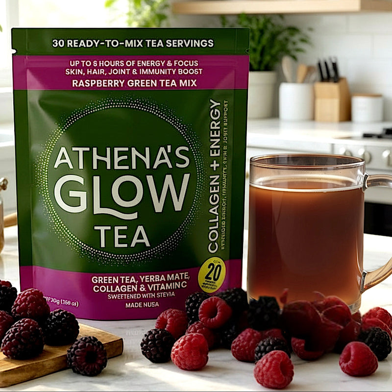 Athena's Glow Tea RASPBERRY package with a cup of tea and berries on a kitchen counter.