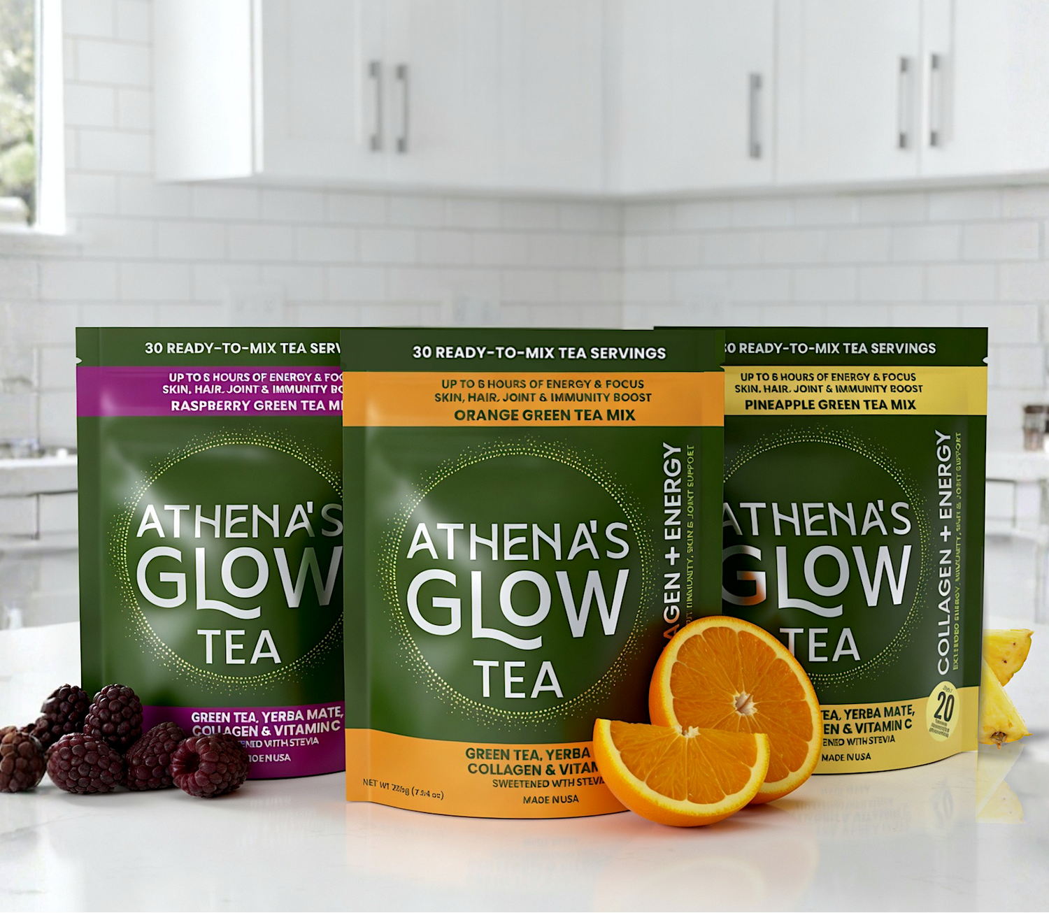 Three packages of Athena's Glow Tea on a kitchen counter with fruits.