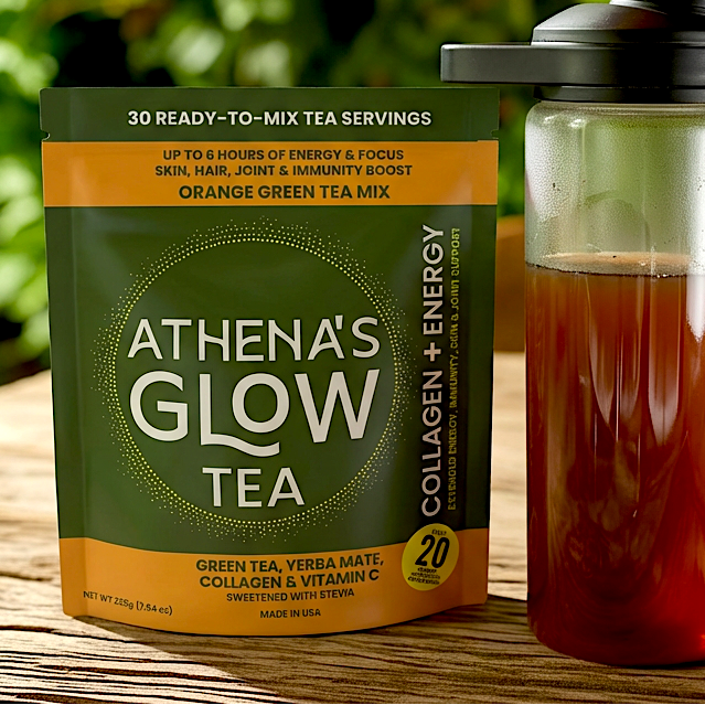 Athena's Glow Tea package and a glass bottle with tea on a wooden surface outdoors.