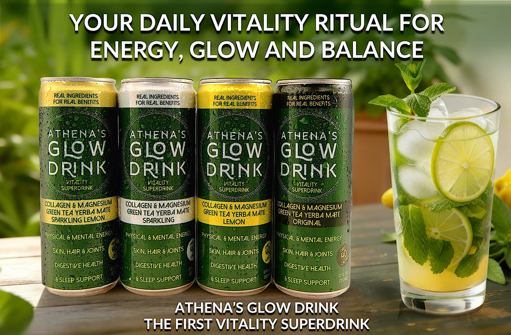 Athena's Glow Drink cans with a glass of a mocktail garnished with lime and mint leaves on a wooden surface.