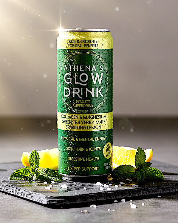 Green can of Athena's Glow Drink Sparkling  Lemon with lemon slices and mint leaves on a dark surface