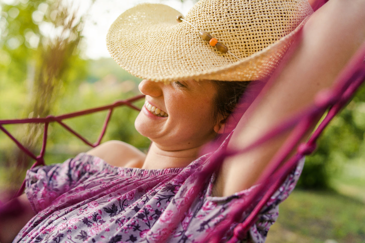 smiling woman relaxing on a hammock