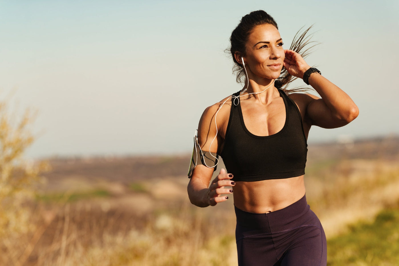 beautiful woman jogging listening to music